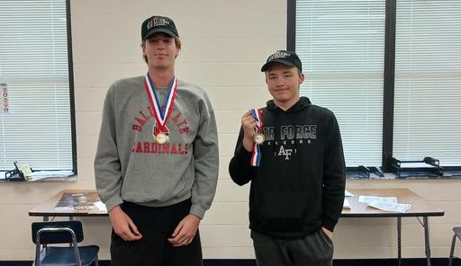 Junior Avery Bauman and senior Landon Carlisle with their medals.